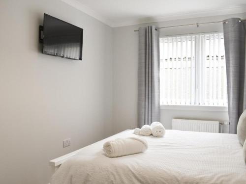 Cathwill - Cosy 4 Star Cottage - Cairngorm National Parkにあるベッド