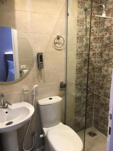 a bathroom with a toilet and a sink and a shower at Casablanca Hotel in Cairo