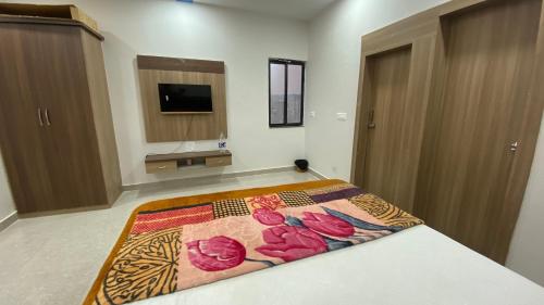 a bedroom with a bed with a rug on the floor at Paradise residency and cafe in Gwalior