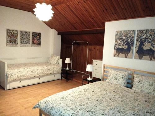 1 Schlafzimmer mit 2 Betten und Holzdecke in der Unterkunft Nest 4 Rest in Konstancin-Jeziorna