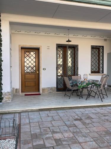 a patio with a table and chairs and a door at il Nido sul lago Trasimeno in Castiglione del Lago