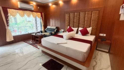 a bedroom with a large bed and a window at Saikat Saranya Resort, Mandarmoni Beach in Mandarmoni