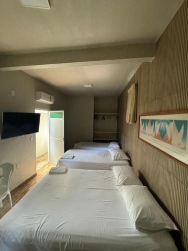 a couple of beds in a small room at Pousada da Celma in Fortaleza