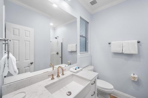 a white bathroom with a sink and a toilet at Sea Sprite in Destin