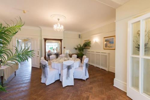 a dining room with a white table and chairs at The Old Vicarage in Bridgnorth