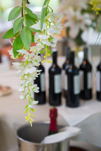 a flower in a pot with bottles of wine at The Old Vicarage in Bridgnorth