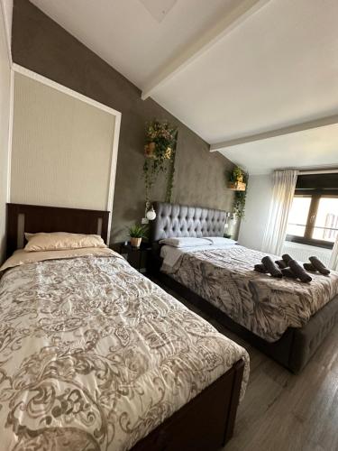 a bedroom with two beds with shoes on them at DEA DREAMS Marghera 43 in Milan