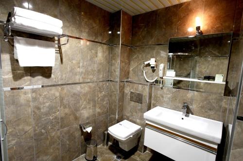 a bathroom with a sink and a toilet at Vip Great Airport Hotel in Arnavutköy