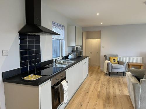 a kitchen with a sink and a counter top at Fleetwood 2 bed cottage in Tunstall