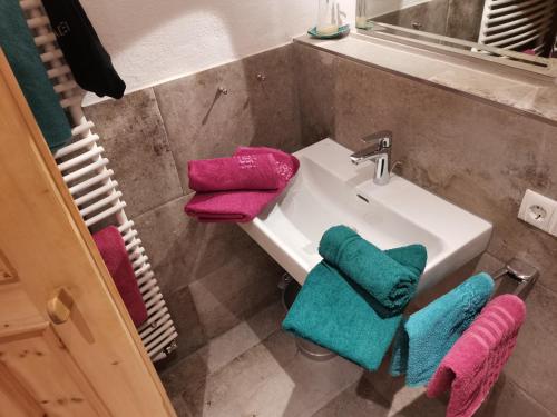 a bathroom with a sink and three towels at Zirbennest in Serfaus