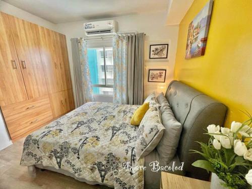 a bedroom with a bed and a couch at mesavirre garden residences in Bacolod