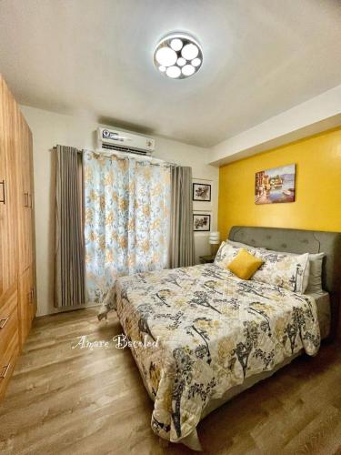 a bedroom with a bed and a window at mesavirre garden residences in Bacolod