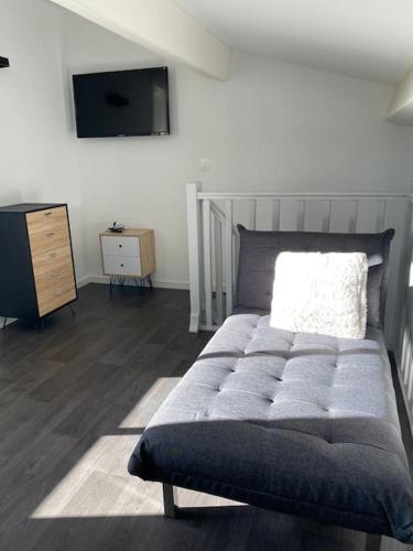 a bedroom with a bed and a dresser and a television at Beau Duplex climatisé T3 vue panoramique Luberon in Pertuis