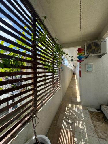 a hallway with a window with blinds on it at Pousada da Celma in Fortaleza