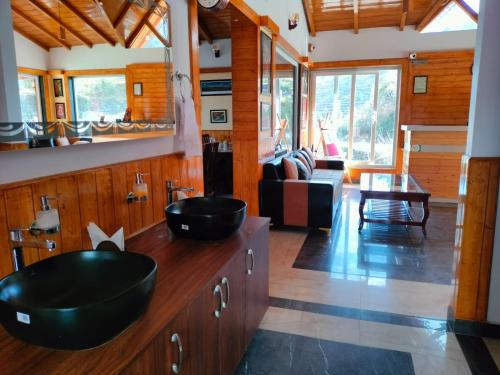 a bathroom with two sinks on a wooden counter at The White mountaina in Mukteshwar