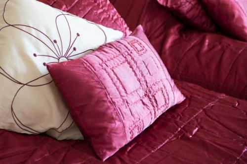 two pillows sitting on top of a bed at The Old Vicarage in Bridgnorth