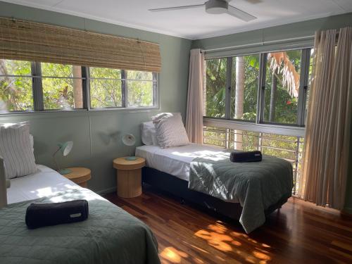 a bedroom with two beds and a window at The Treehouse at Alma Bay in Arcadia