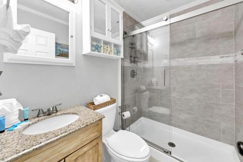 a bathroom with a shower and a toilet and a sink at Misty Harbour 7 in Panama City Beach