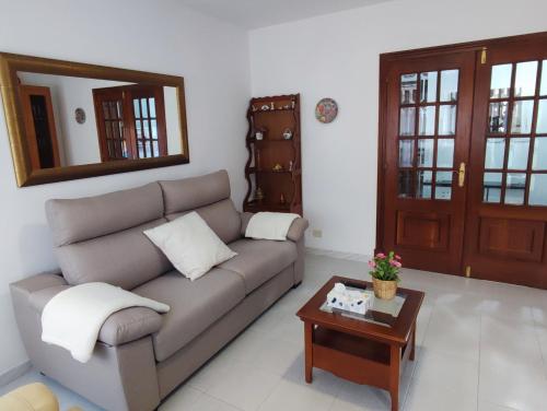 a living room with a couch and a table at Amplio Apartamento con terraza a 150 m playa in Porto do Son