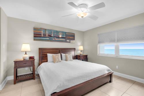 a bedroom with a bed and a window with the ocean at Regency Towers 808 West in Pensacola Beach