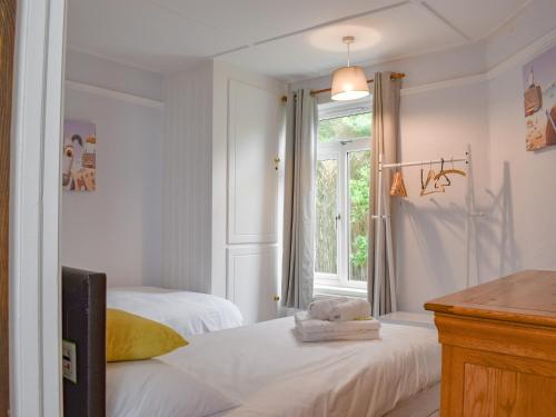 a bedroom with two beds and a window at Hillside in Praa Sands