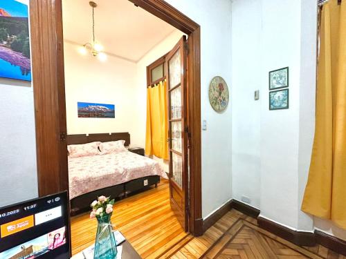 a bedroom with a bed and a tv in a room at Antiguo Maipu in Buenos Aires
