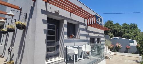 a balcony with chairs and a table on the side of a building at Filia's Memories Apartments in Agios Nikolaos