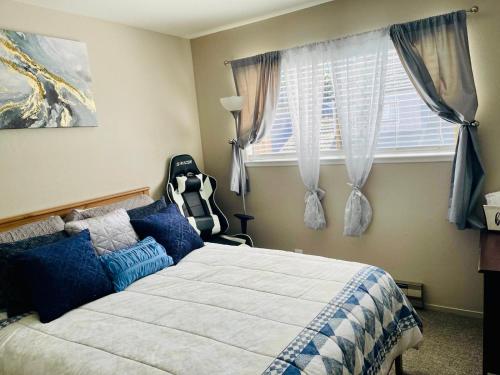 a bedroom with a bed with blue pillows and a window at Wonderful Private Queen Bedroom in Santa Clara