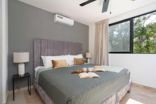 a bedroom with a large bed with two books on it at 2BD with Rooftop Pool near Beach in Tulum