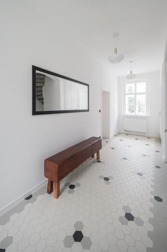a white room with a bench on the wall at Stará škola - Alte Schule, Loučná in Jindřichovice