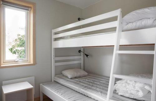 a room with two bunk beds and a window at Lövhults Camping & Stugby in Nässjö