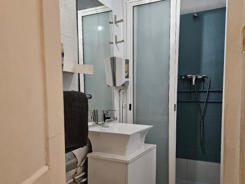 a bathroom with a white sink and a mirror at Window to Lisboa I in Lisbon