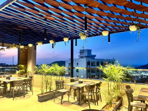 a patio with tables and chairs on a roof at Maruti Group of Hotels - The Shivam in Nāthdwāra