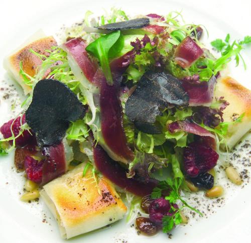 a plate of food with a salad on it at Fonda Ca la Manyana in Sant Juliá de Vilatorta