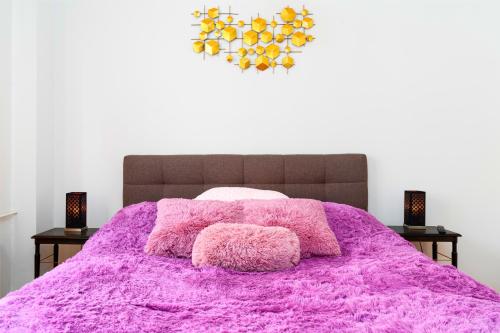 a bedroom with a pink bed with two night stands at Brilliant Deluxe Suite in Prague