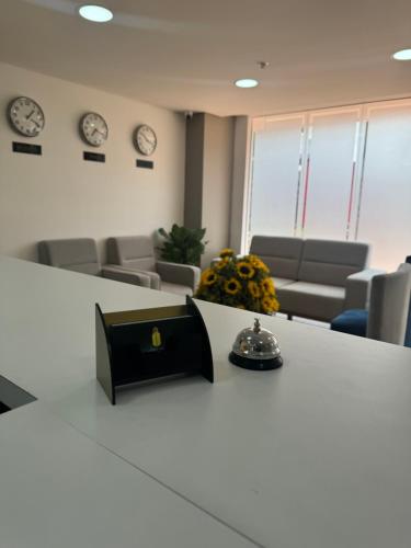 an office with clocks on the wall and a table at Hotel WLH Gold Bogota in Bogotá