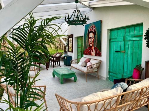 a living room with a green door and some plants at Bohemian Eco lodge át lake Balaton in Kisapáti