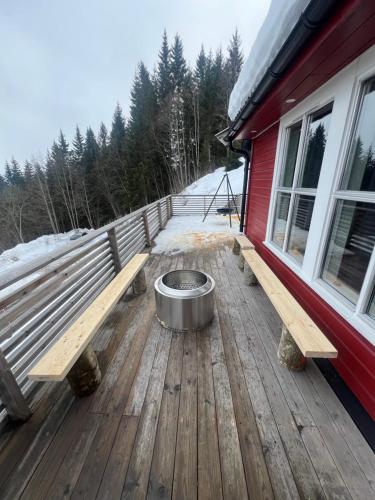a dog bowl sitting on a deck next to a bench at All inclusive villa in Lillehammer