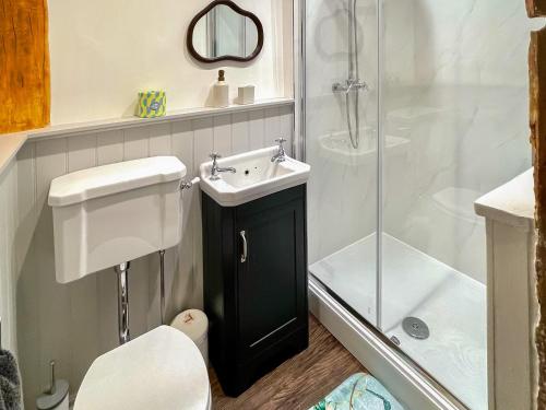 a bathroom with a sink and a shower at The Cottage At Harple Farm in Detling