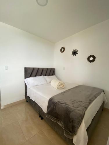 a bedroom with a bed in a white room at CASONA HOTEL LA DIVISA in Santa Rosa de Cabal