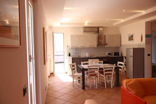a kitchen and dining room with a table and chairs at Giulio's terraces in the bay in Portovenere