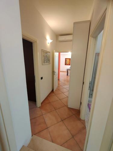 a hallway with a tile floor and an open door at Giulio's terraces in the bay in Portovenere