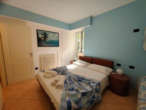 a bedroom with a bed with towels on it at Giulio's terraces in the bay in Portovenere
