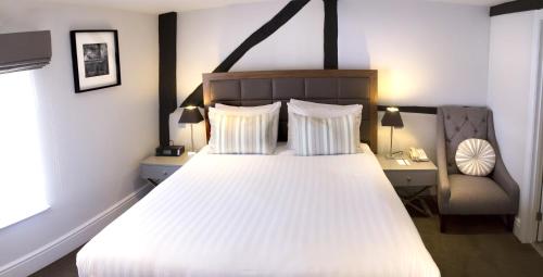 a bedroom with a large white bed and a chair at Best Western Red Lion Hotel in Salisbury