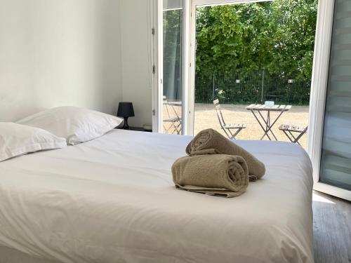 a bed with towels sitting on top of it at Au coeur des Chateaux de la Loire in Fondettes