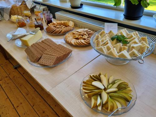 a table with many different types of food on it at Sofielund Vandrarhem & Camping in Sala