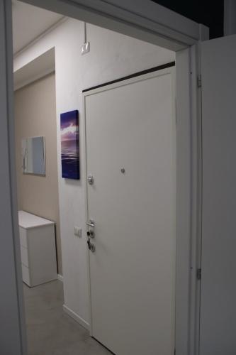an open door in a room with a white wall at Travelounge Milano San Siro in Milan
