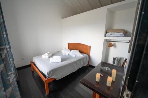 a bedroom with a bed and a table with candles at Casa Atlantida - Sea front in Faja Grande