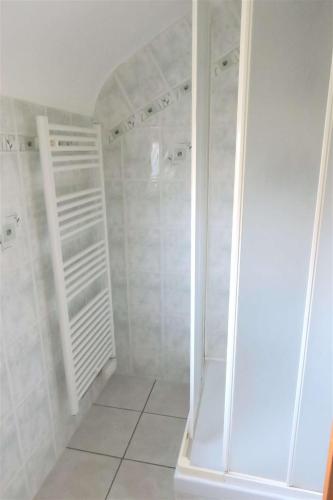 La salle de bains est pourvue d'une douche à l'italienne et de carrelage blanc. dans l'établissement Maison bretonne avec jardin clos au centre de PERROS-GUIREC - Réf 928, à Perros-Guirec