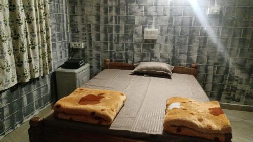 a bedroom with a bed with two slices of bread at Vasu estate stay in Madikeri